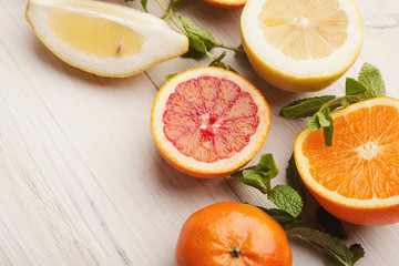 Heap of citruses on white wood, closeup