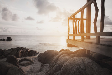 view of rustic hut by the sea at sunset - obrazy, fototapety, plakaty