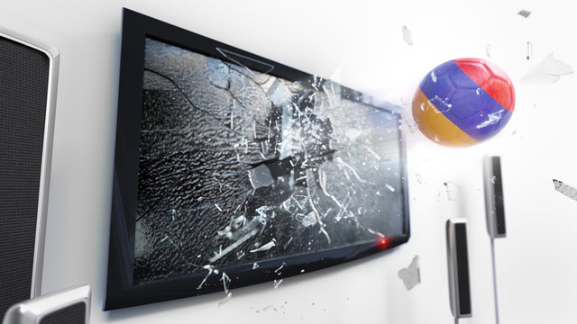 Soccer ball with the flag of Armenia kicked through a shattering tv screen.(3D rendering series)