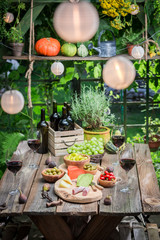 Evening in summer garden with wine and fruits