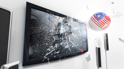 Soccer ball with the flag of Malaysia kicked through a shattering tv screen.(3D rendering series)