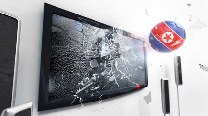 Soccer ball with the flag of North Korea kicked through a shattering tv screen.(3D rendering series)