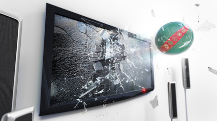 Soccer ball with the flag of Turkmenistan kicked through a shattering tv screen.(3D rendering series)