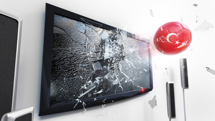 Soccer ball with the flag of Turkey kicked through a shattering tv screen.(3D rendering series)