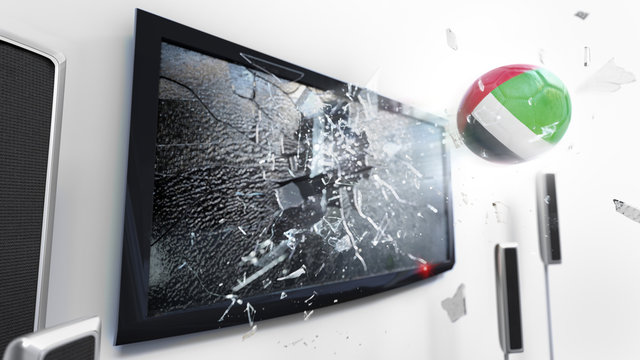 Soccer ball with the flag of United Arab Emirates kicked through a shattering tv screen.(3D rendering series)