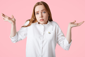 Puzzled lovely female student can`t recollect in her mind necessary information for passing exam,...