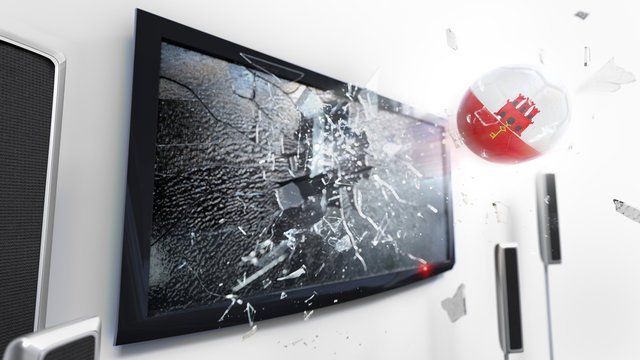 Soccer ball with the flag of Gibraltar kicked through a shattering tv screen.(3D rendering series)