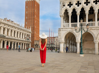 Italy beauty, pretty girl in front of famous St Mark's Campanile tower, San Marco square in Venice...