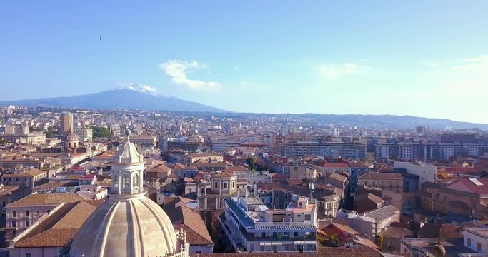 Beautiful aerial view of the Catania city with main Cathedral and Etna volcano on the background. Amazing old town view.