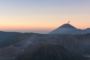 Fototapeta na wymiar Mount Bromo volcano (Gunung Bromo) during colorful sunrise from viewpoint on Mount Penanjakan in Bromo Tengger Semeru National Park, East Java, Indonesia
