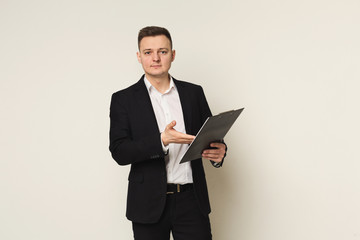 Serious man with notepad on white background