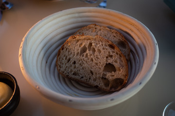 Two slices of bread in a basket on a restaurant table