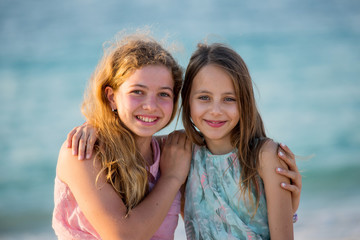 Fototapeta na wymiar Two young girl friends on the beach