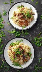 Italian Mushroom risotto with parmesan cheese and wild rocket on top.