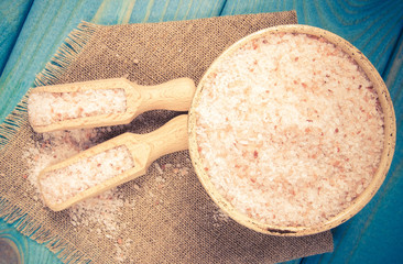Pink Himalayan salt on a blue background.
