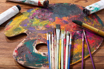 colorful paint brushes on a  palette