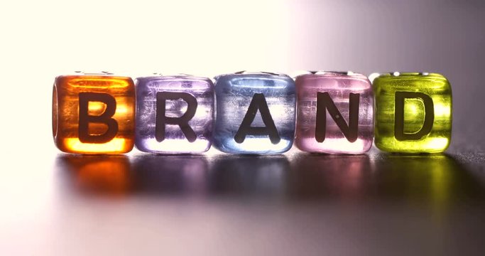 Close up light moving on english alphabet cube block which arrangement as BRAND word , the business marketing branding concept , 4K Dci resolution