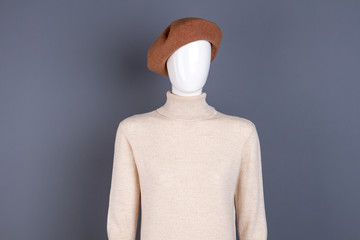 Mannequin in beret and turtleneck sweater. Female warm pullover on dummy. Female autumn trendy style.