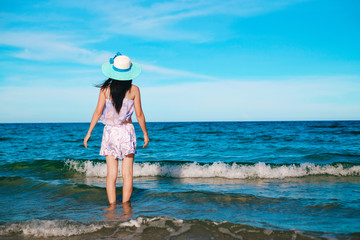 woman traveler in bikini enjoying for view of the beautiful sea on her holiday.beautiful Lady tourist walking on the beach.