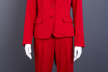 Close up red blazer and trousers for women. Mannequin dressed in women business suit, cropped image. Ladies high quality outfit.