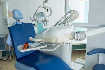Comfortable chair and working apparatus of dentist in light clean office in daylight. 