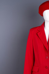 Female mannequin in red clothing, copy space. Red beret and jacket for ladies. Feminine classy clothes and accessories.