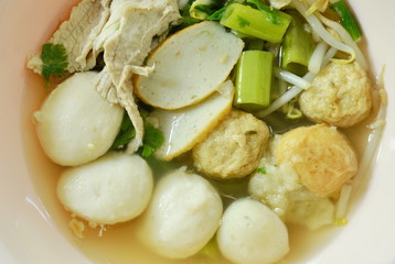 boiled fish and shrimp ball topping slice pork in clear soup on bowl