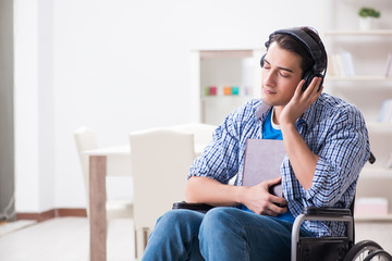 Fototapeta premium Disabled man listening to music in wheelchair