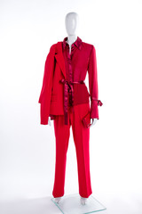 Red blazer, trousers, blouse and wallet. Female mannequin clothed in red elegant suit. Women classy garment.