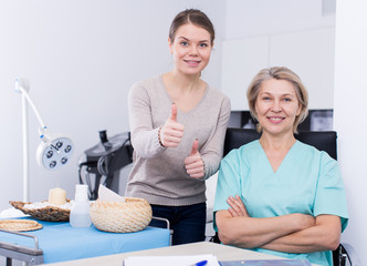 Obraz premium Beautician and satisfied female client