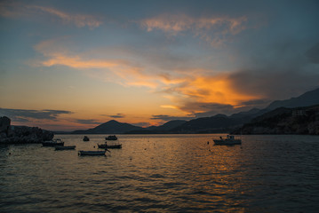 Fishing boats in sea, spectacular sunset, near Budva, Montenegro