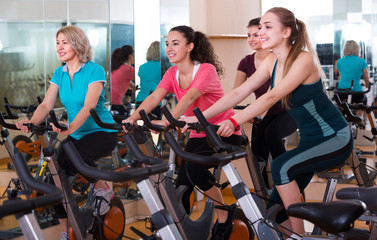 Fototapeta na wymiar Females riding stationary bicycles