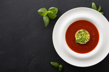 Cold tomato soup gazpacho with avocado top view