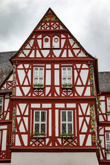 Fototapeta na wymiar Old townhall in a half timbered house with red wood 