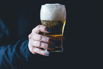 Woman holds a glass of beer