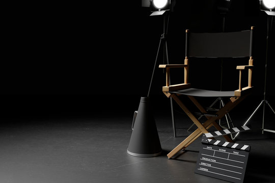 Director Chair,Megaphone,Movie Clapper and lighting equipment on dark background.