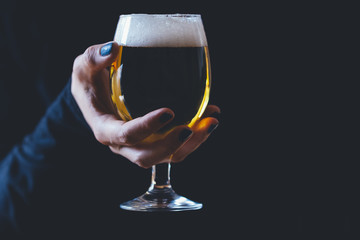 Woman holds a glass of beer
