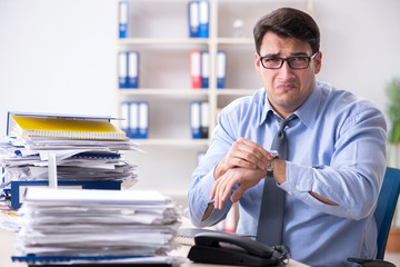 Extremely busy businessman working in office