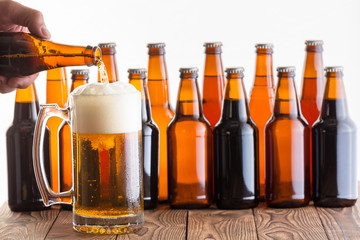 Man pouring homemade beer into a glass mug