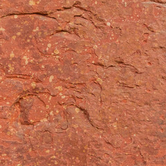 Red rough stone texture background. Material construction and architectural detail.