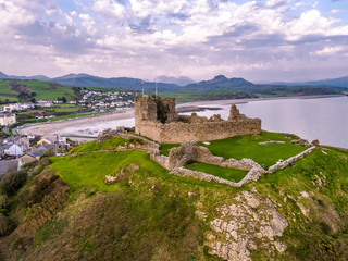 Fototapeta premium Aerial view of Criccieth castle and beach at dawn, Wales, UK