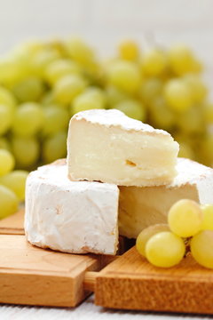 Brie type of cheese and grape. Camembert cheese.