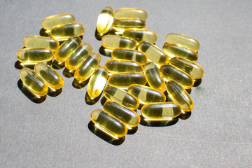 Cod liver oil omega 3 capsules on the gray background