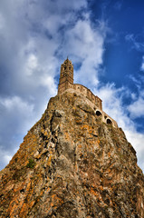 Ancient Chapel Saint Michel de Aiguilhe standing at a very steep volcanic needle (Le Puy en Velay, France)
