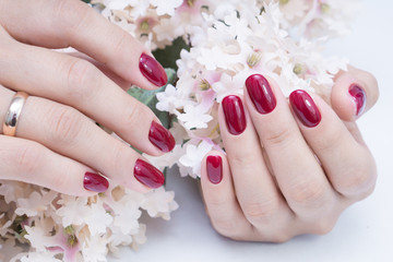 Attractive manicure on women's hands. Natural finger nails with stylish nail art.