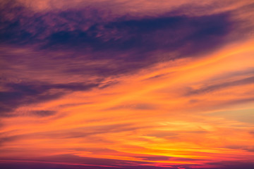 Naklejka na ściany i meble Beautiful cloudscape at scarlet sunset with colorful contrasting cirrus clouds 