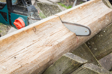Cut logs for firewood with a chain saw