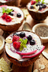 Fruit dessert. Pitaya fruit (Dragon fruit), blueberries and raspberries, mint, almond flakes, chia seeds and sesame seeds. Healthy and delicious dessert or breakfast, vegetarian food