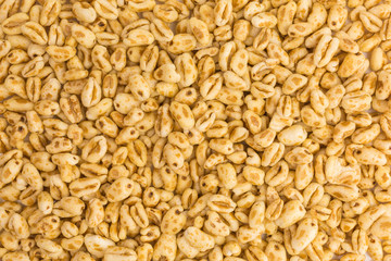 background of puffed wheat cereal with honey