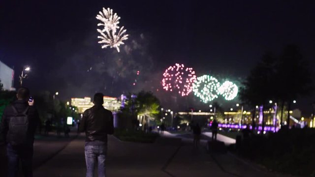 Slow motion of firework in night city. People shooting firework show by smartphone.